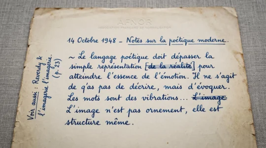 Gros plan d'un feuillet manuscrit original de Boris Vian montrant une écriture à l'encre bleue avec ratures barrées et annotation marginale, sur papier vieilli à en-tête AFNOR.